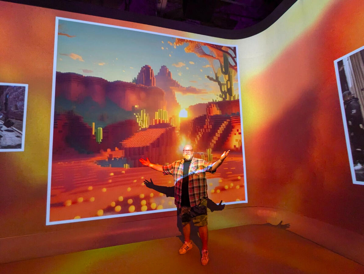 Dré looking relatively small compared to the immersive floor-to-ceiling projections at the Illuminarium.